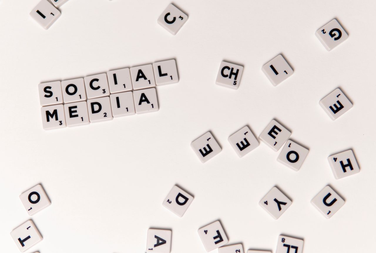 creative Scrabble tiles spelling Social Media on a white background, symbolizing digital communication.